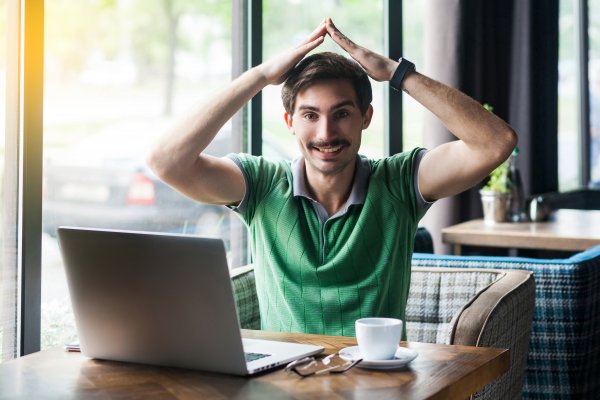 Happy guy in front of a safe computer!